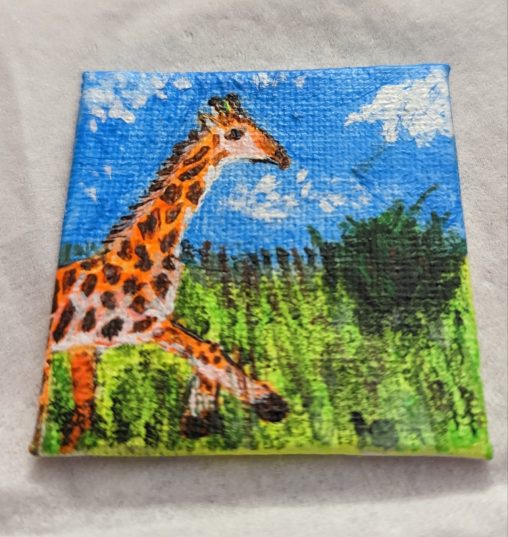 A painting of a giraffe frolicking in a field. The second image is of the same small painting, only with a black light on it to show that the orange green and blue paint is blacklight reactive.